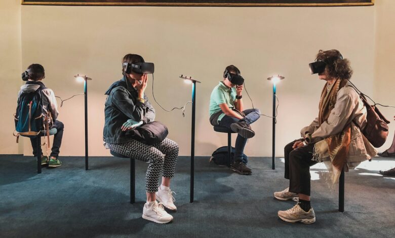 four person playing virtual reality goggles