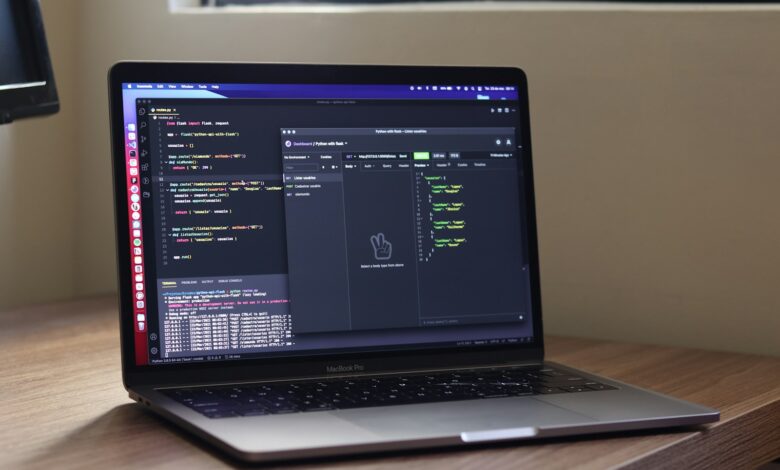 a laptop computer sitting on top of a wooden desk