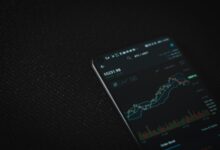 black android smartphone on black textile