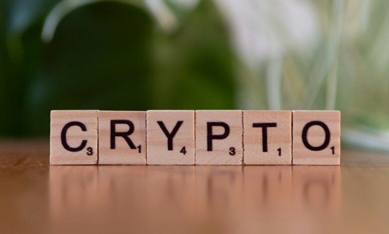 A wooden block spelling crypt on a table